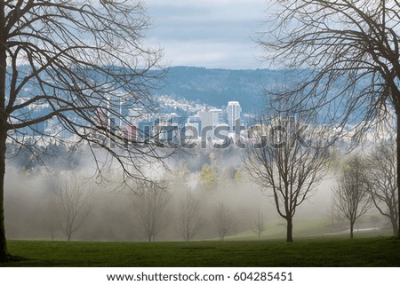 Foggy cold morning in the park scenic view of Portland Oregon downtown skyline during winter season