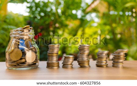 stacking gold coins with green bokeh background ,Business Finance and Money concept