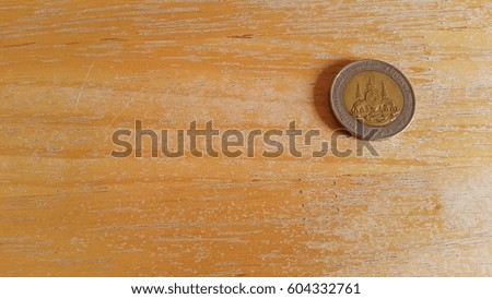 Thailand coin on the wooden floor.