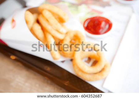 Picture blurred  for background abstract and can be illustration to article of Crunchy Fried Onion Rings with Ketchup