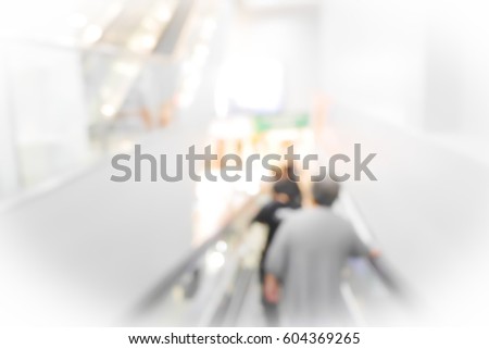 Picture blurred abstract background of people use escalator