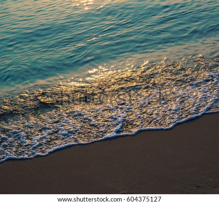 Soft wave of blue ocean on sandy beach. Background / soft focus picture