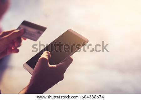 Female hands using mobile banking on smart phone / soft focus picture / Vintage concept