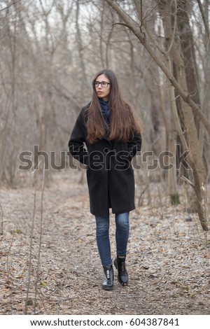 beautiful brunette girl in a dark fairy forest