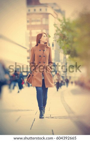 photo of beautiful young woman on one of the streets exploring the town
