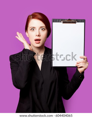 beautiful surprised young woman with clipboard on the wonderful purple background
