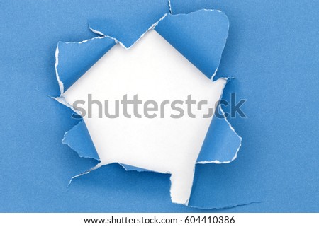 Blue ripped open paper on white paper background