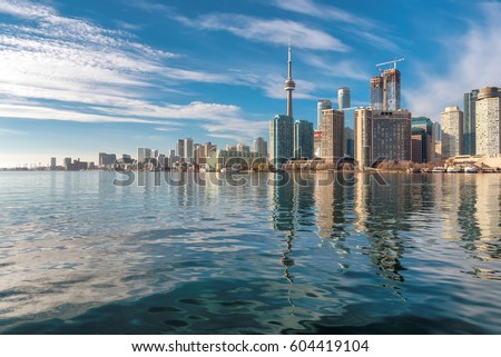 Toronto city skyline and reflection in the lake at sunset, Ontario, Canada.