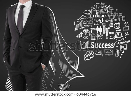 Man with drawn cape and business sketch on dark background. Leadership concept
