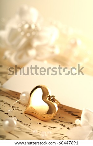 gold heart and wedding invitation