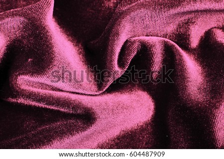 Velvet dress material cloth texture pattern. 
tailoring stitching concept. Shiny beautiful fashion fabric. Shiny clothing material sample. Creased fabric. Rose purple.