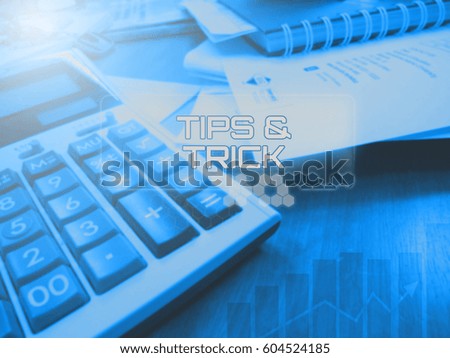 Business concept, showing calculator and paperwork with digital screen TIPS AND TRICK.