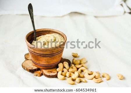Cashew sauce, raw vegan cheese from nuts with nutritional yeast. Dairy free. Healthy or diet food concept.  Rustic Royalty-Free Stock Photo #604534961