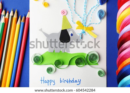 Handmade gift card, colorful ribbons and crayons, close up