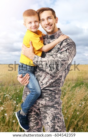 Happy soldier with son, outdoor