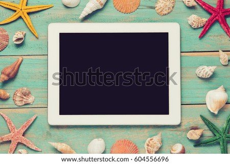 Shells and starfishes on blue wooden background. Copy space for your text.
