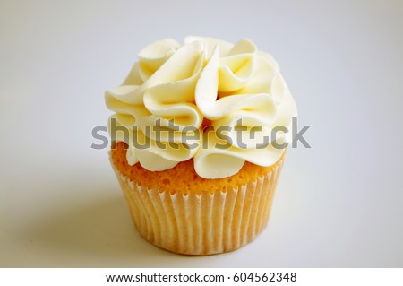 Cupcake with cream on white background. Picture for a menu or a confectionery catalog.