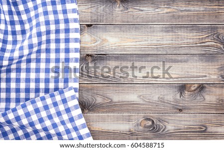 White old wooden table with blue checkered tablecloth, top view with copy space