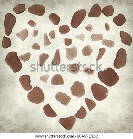 textured old paper background with heart symbol made of seaglass