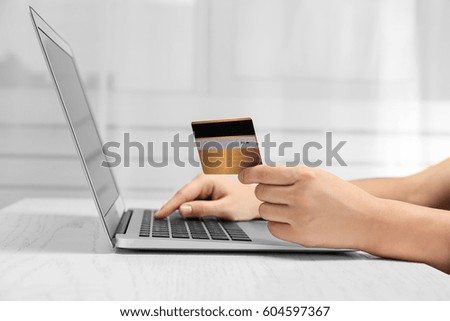 Woman using laptop and credit card for online shopping