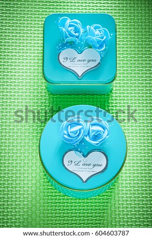 Metal blue present boxes on green background top view celebrations concept.