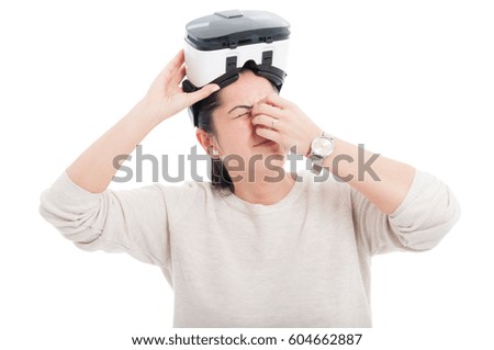Young woman with headache taking a break from virtual gaming isolated on white background