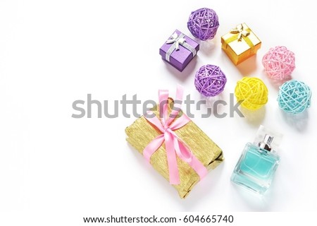 Golden gift box with a pink ribbon, colorful balls of rattan and a souvenir toy horse. Purchase of presents, congratulation of a woman on her birthday, New Year and other holidays. Flat lay photo