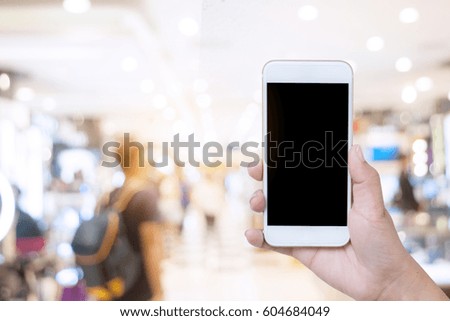 Close up of hands using smartphone on blurred background