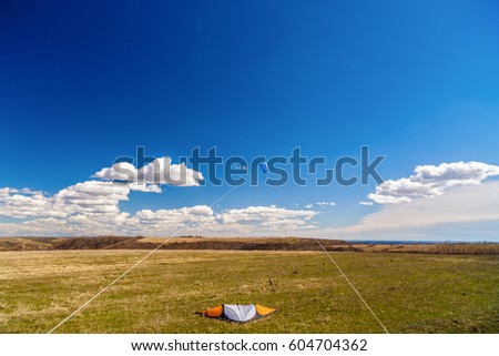 picture with a kite in the sky with clouds