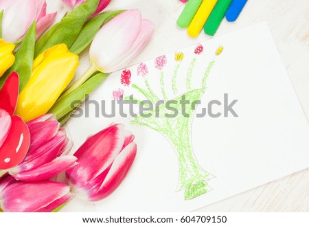 Bouquet of tulips  and kid's picture with vase and flowers for mother