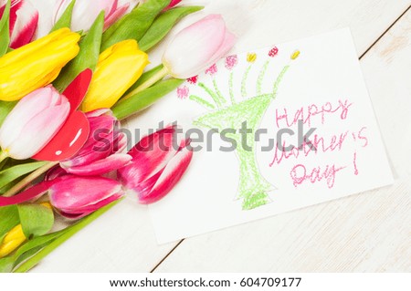 Bouquet of tulips  and kid's picture with greetings for mother