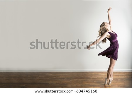 Ballerina in a purple dress dancing en pointe
