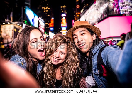 Group of friends taking a selfie in Times Square, Manhattan