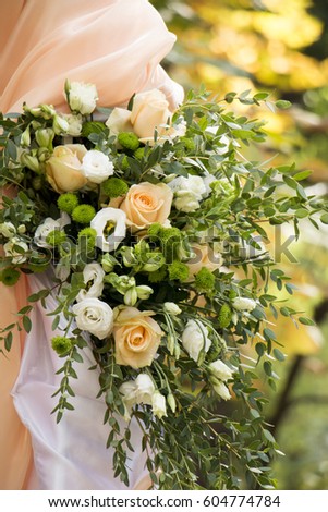 Wedding arch of fresh flowers in pastel colors. Eucalyptus, peach roses, and eustoma flowers. Autumn wedding floristic. Close up