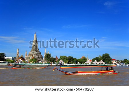 Long tail motor boat cruise in front of Wat Arun in Chaopraya river Royalty-Free Stock Photo #60478207
