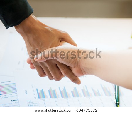 grasp hands, Partner hand between a Businessman and a Businesswoman on white background ,Business concept