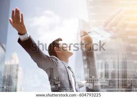Success businessman in the city raising his arms, open palms, with face looking up - financial freedom concepts, double exposure effect Royalty-Free Stock Photo #604793225