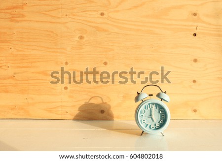 Blue alarm clock and evening light in the room