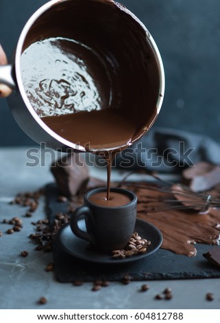 Cup of hot chocolate against grey stone background