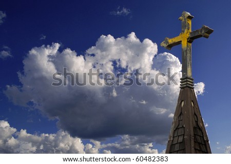 Steeple Cross of Church with Blue Sky in background