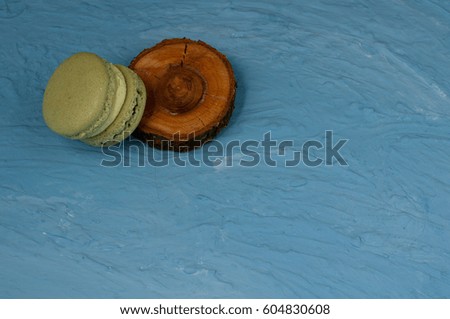 Delicious multicolored cake macaron or macaroon on blue background.Various green colour macarons.