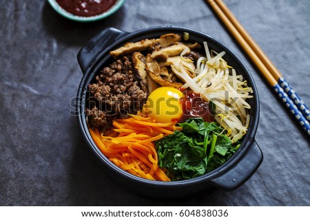 Traditional Korean dish- bibimbap: rice with vegetables and beef Royalty-Free Stock Photo #604838036