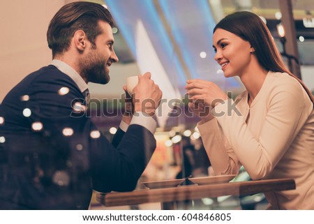 Lovely romantic couple sitting in a cafe with coffee Royalty-Free Stock Photo #604846805