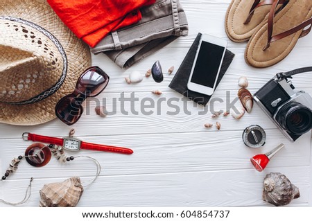 Top view of female  travel accessories set on wooden background with copy space Royalty-Free Stock Photo #604854737