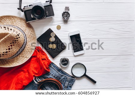 Top view of travel accessories set on wooden background with copy space Royalty-Free Stock Photo #604856927