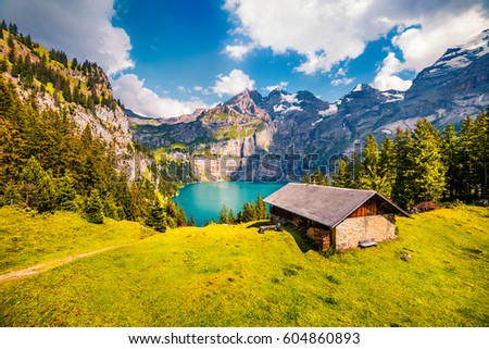 Colorful summer morning on the unique Oeschinensee Lake. Splendid outdoor scene in the Swiss Alps with Bluemlisalp mountain, Kandersteg village location, Switzerland, Europe.
