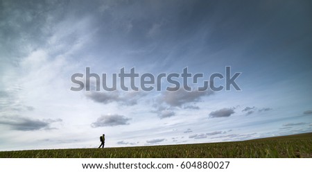 A lonely man against the background of a large sky.
