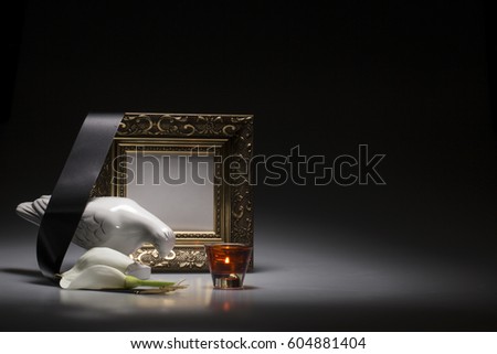 mourning dove with blank gold frame for sympathy card on dark background