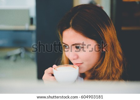 Office girl with beautiful smile drink coffee after lunch