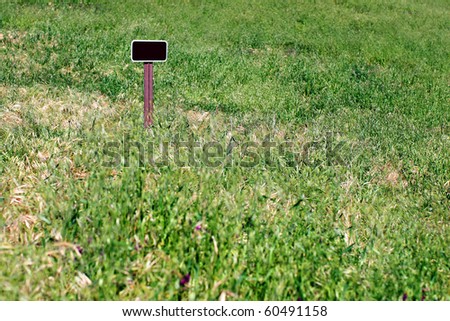 Empty sign in the middle of a field